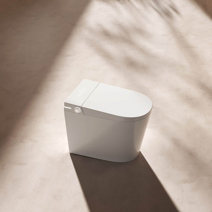 Origin smart toilet shown from the front with its LED control panel, in a minimalist studio setting